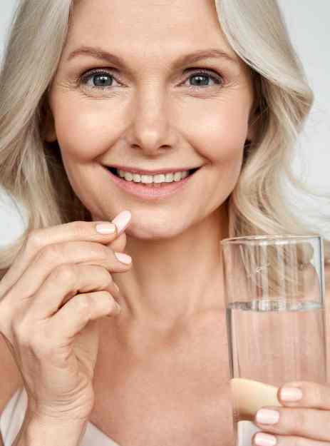 women taking supplements pretty pea womens health supplements menopause supplements - Pretty Pea Woman taking Pretty Pea supplements as part of daily wellness routine